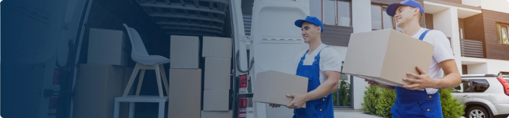 Movers loading packed boxes into a vehicle